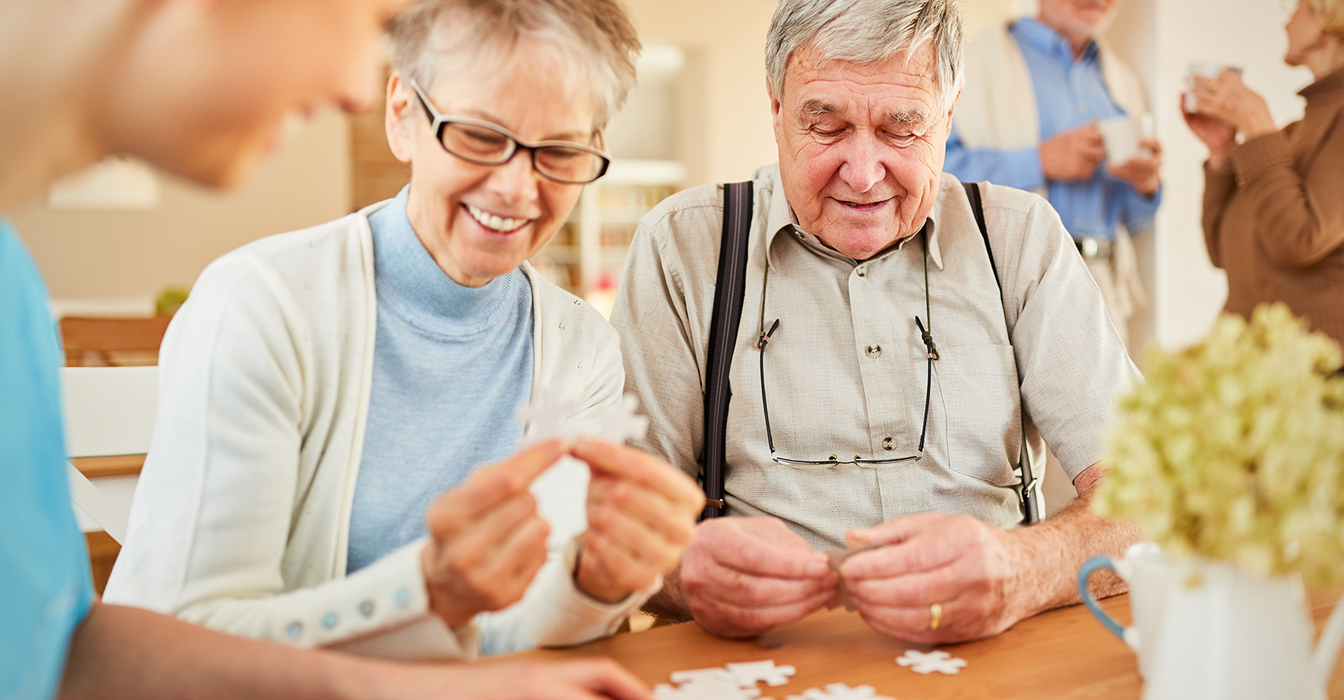 Happy elderly couple putting together a puzzle