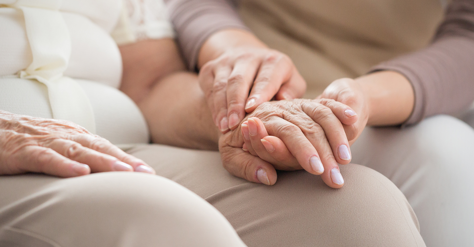A woman holding hands with an elderly woman