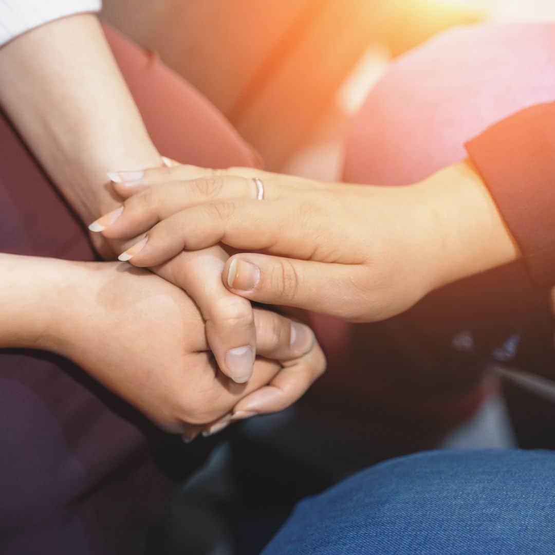 clasping hands in support