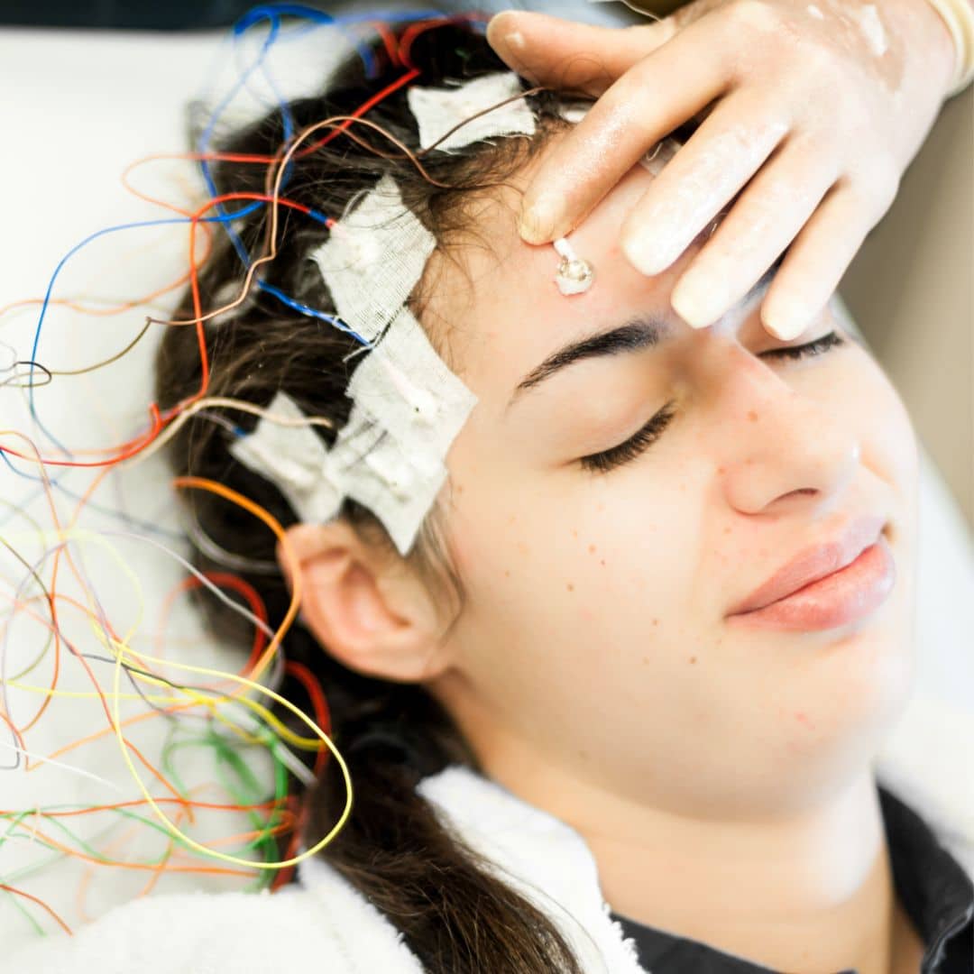 woman with electrodes attached to her head