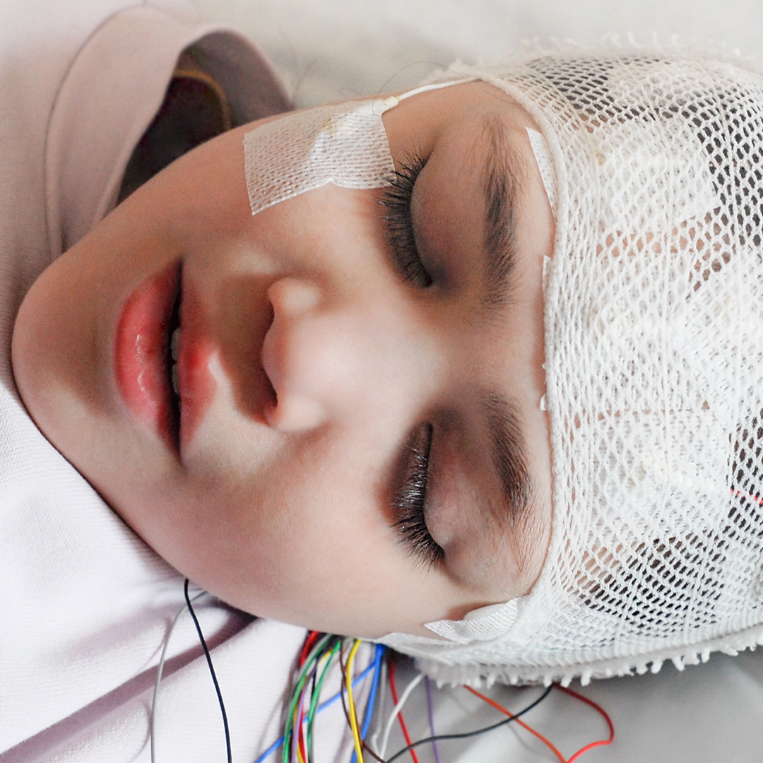 Image of young girl in the hospital with her head covered