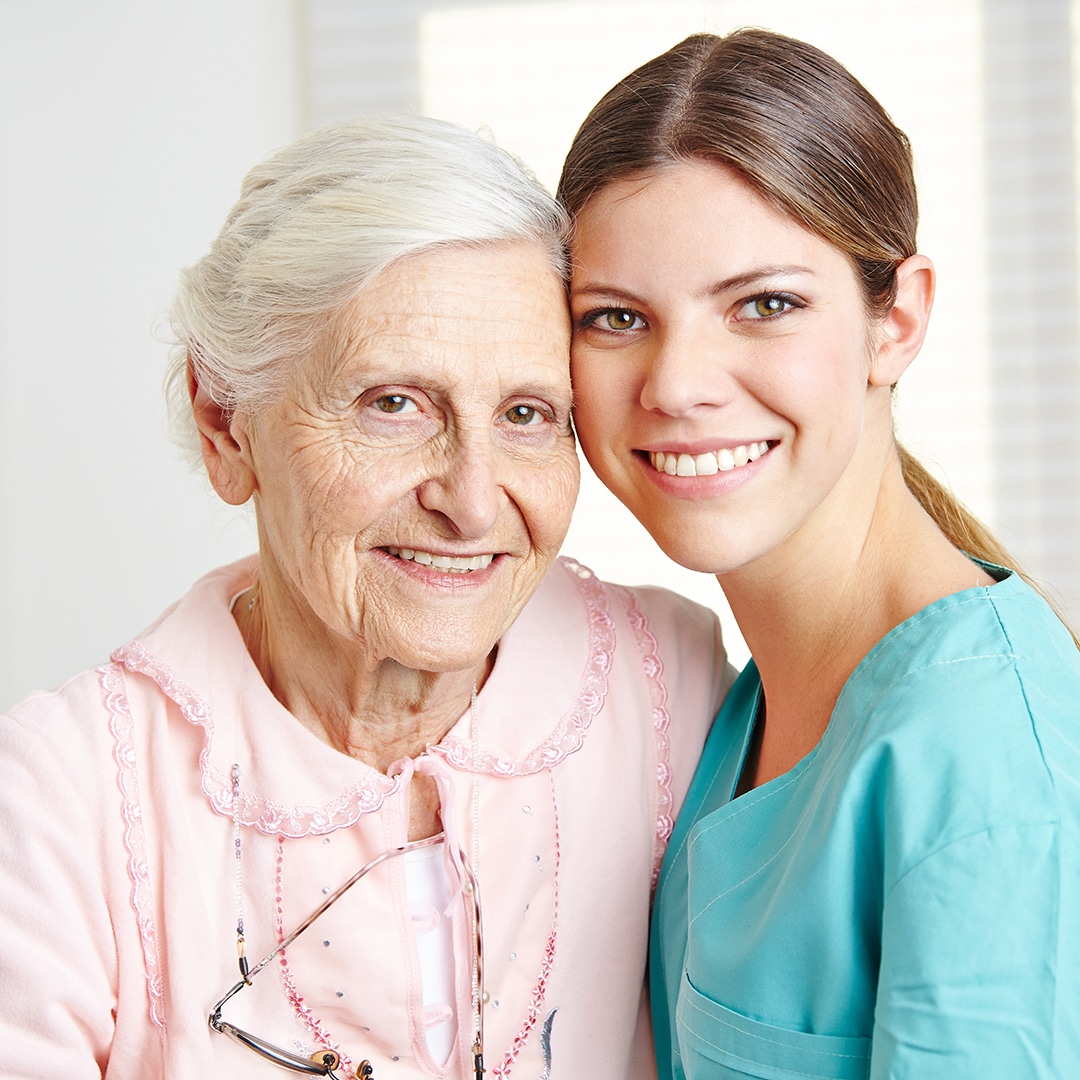 A happy older lady with her caregiver