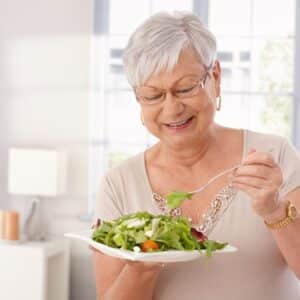 old woman eating salad