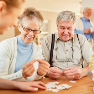 old couple putting together a puzzle