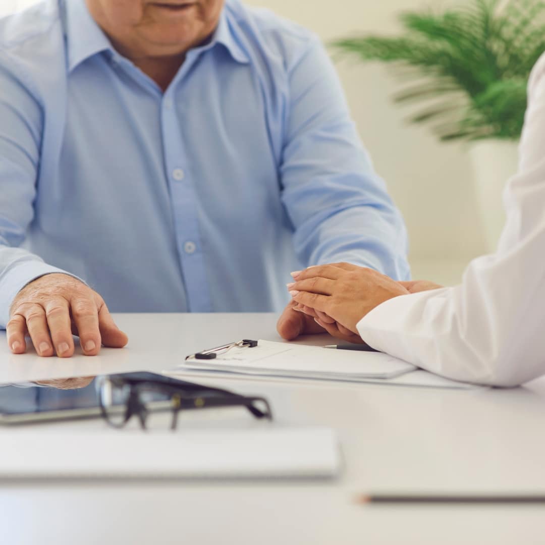 Elderly man talking to person