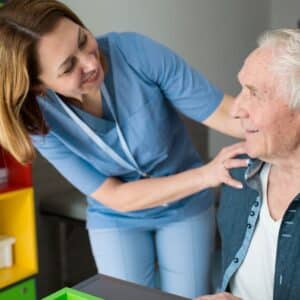 man with Parkinson's receiving care from nurse