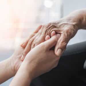 young hand holding old hand