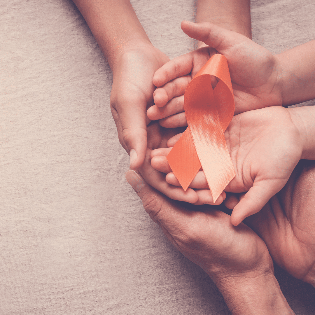 Hands holding an orange ribbon