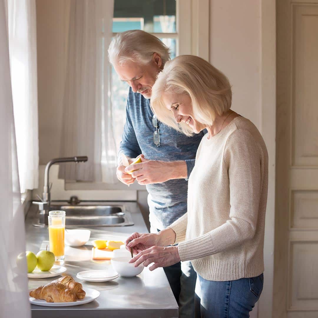 Senior couple preparing food in the kitchen
