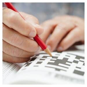 person trying to complete a crossword puzzle