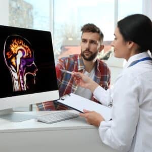 neurologist looking at a scan with a patient