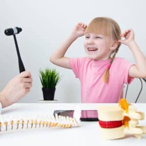 little girl smiling with neurologist