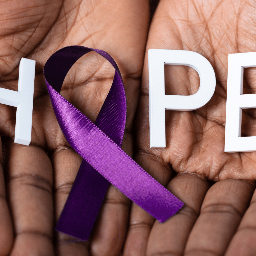 Hands holding a purple ribbon and the word hope