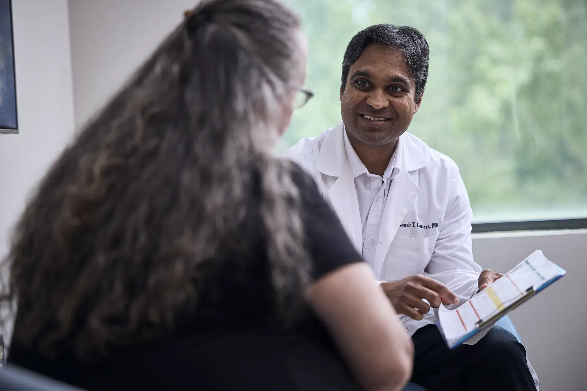Dr. Lazarus explaining chart to patient